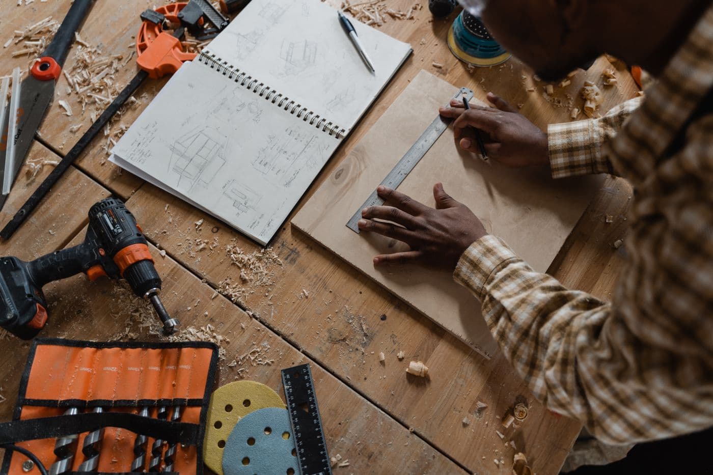 Joiner measuring timber at the bench