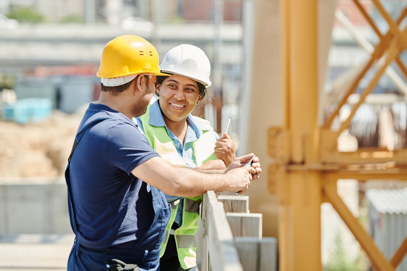 Project manager and client reviewing plans on site