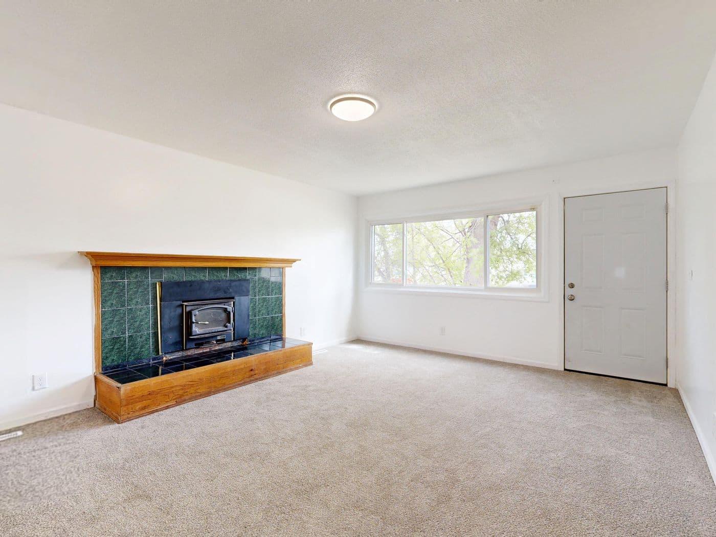 Living room with dated central lighting before the redesign