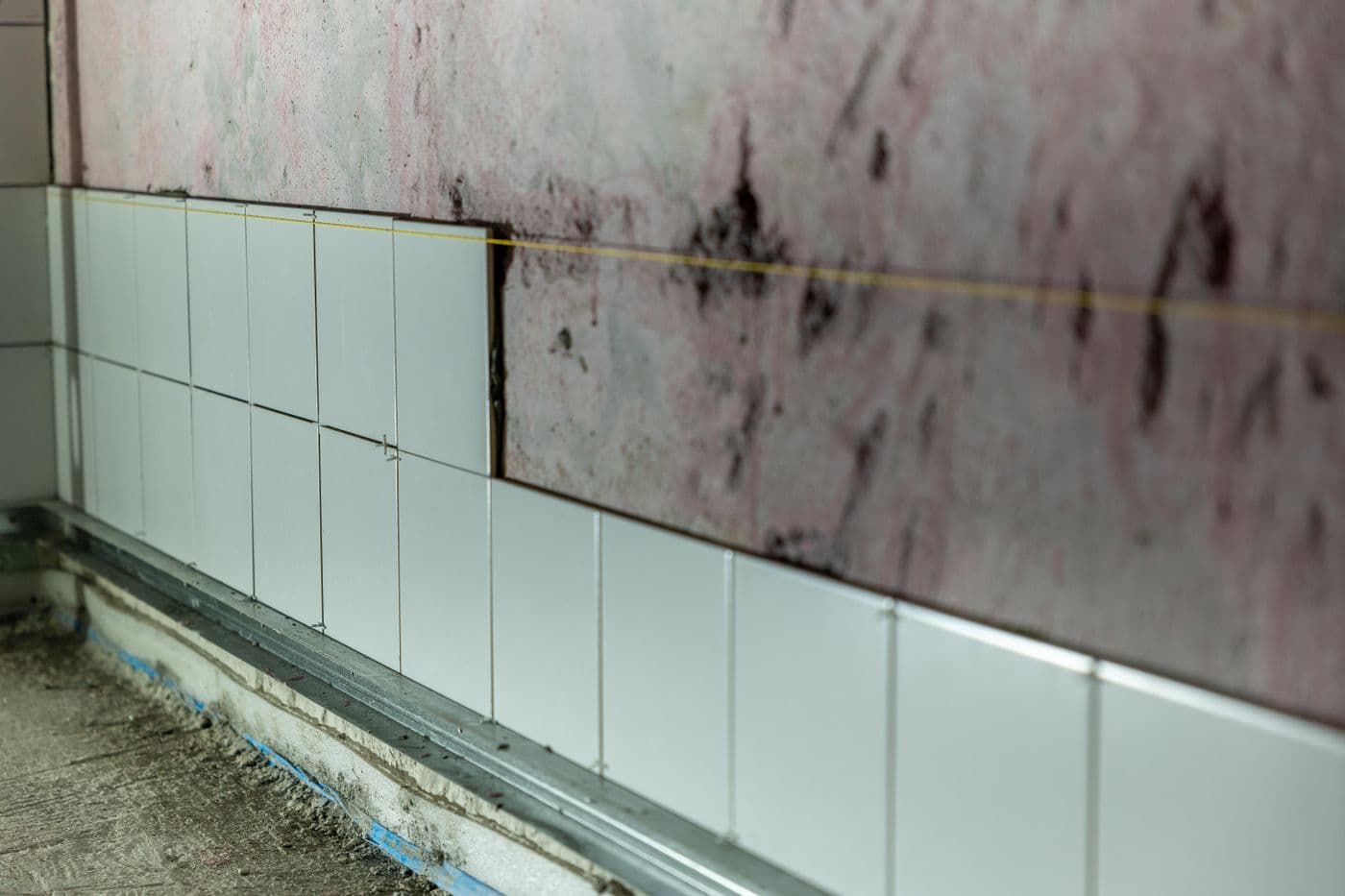 Bathroom walls part-tiled during the fit-out